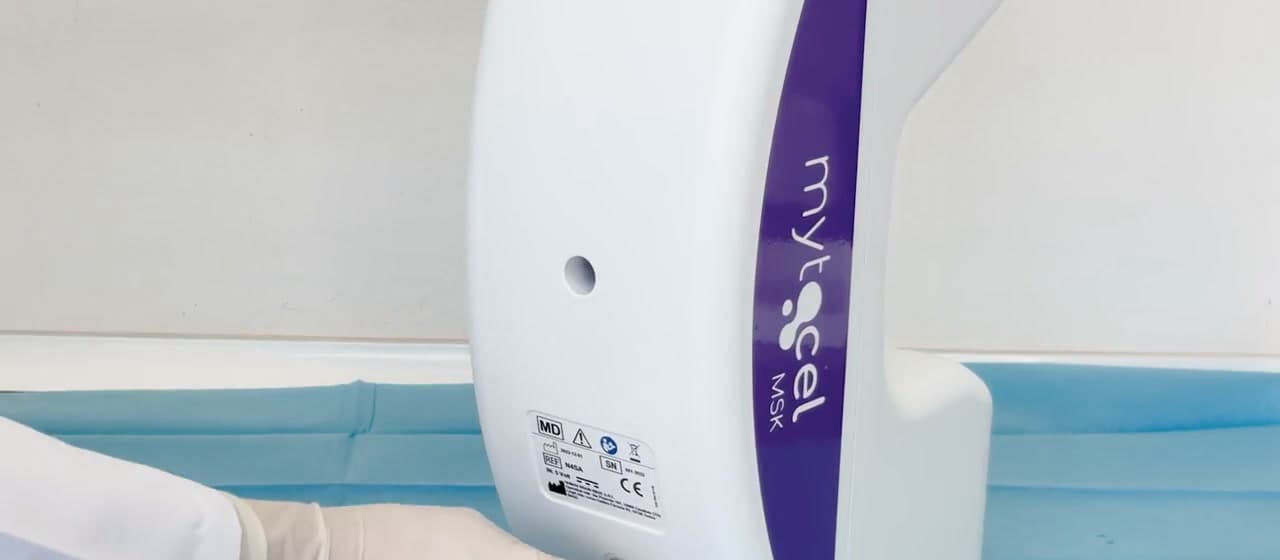 The Mytocel MSK processing unit on a sterile drape, its branded side panel and device label in view